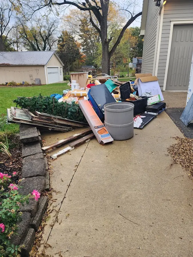 Dumpster being loaded with debris for Roofing Dumpster Rental in Dry Ridge